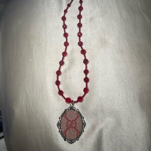 Elegant Red Beaded Necklace with Ornate Pendant